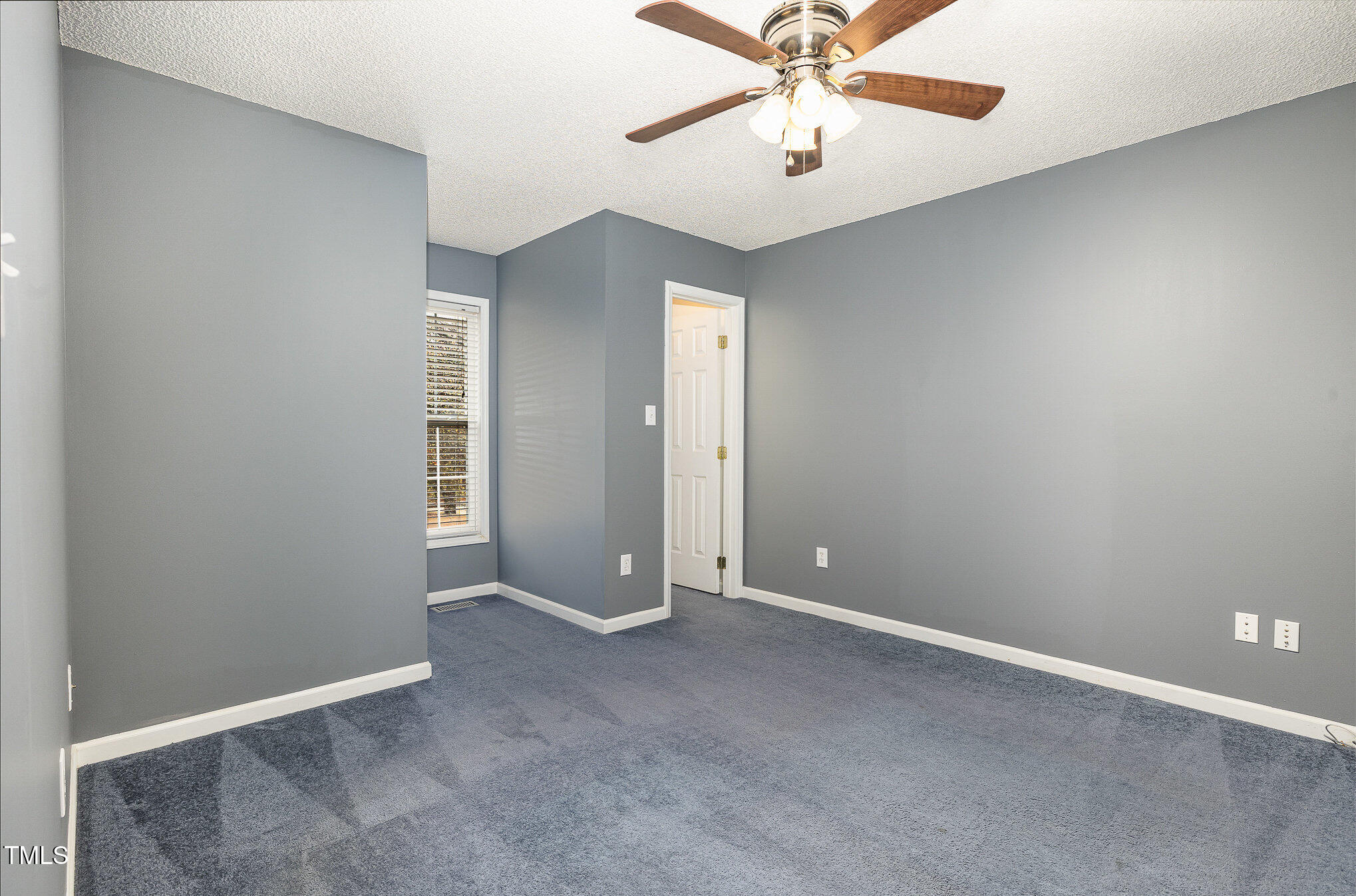 3733 Polenta Road Clayton, NC 27520 - Photo 22 of 51 an empty room with closet and a chandelier fan