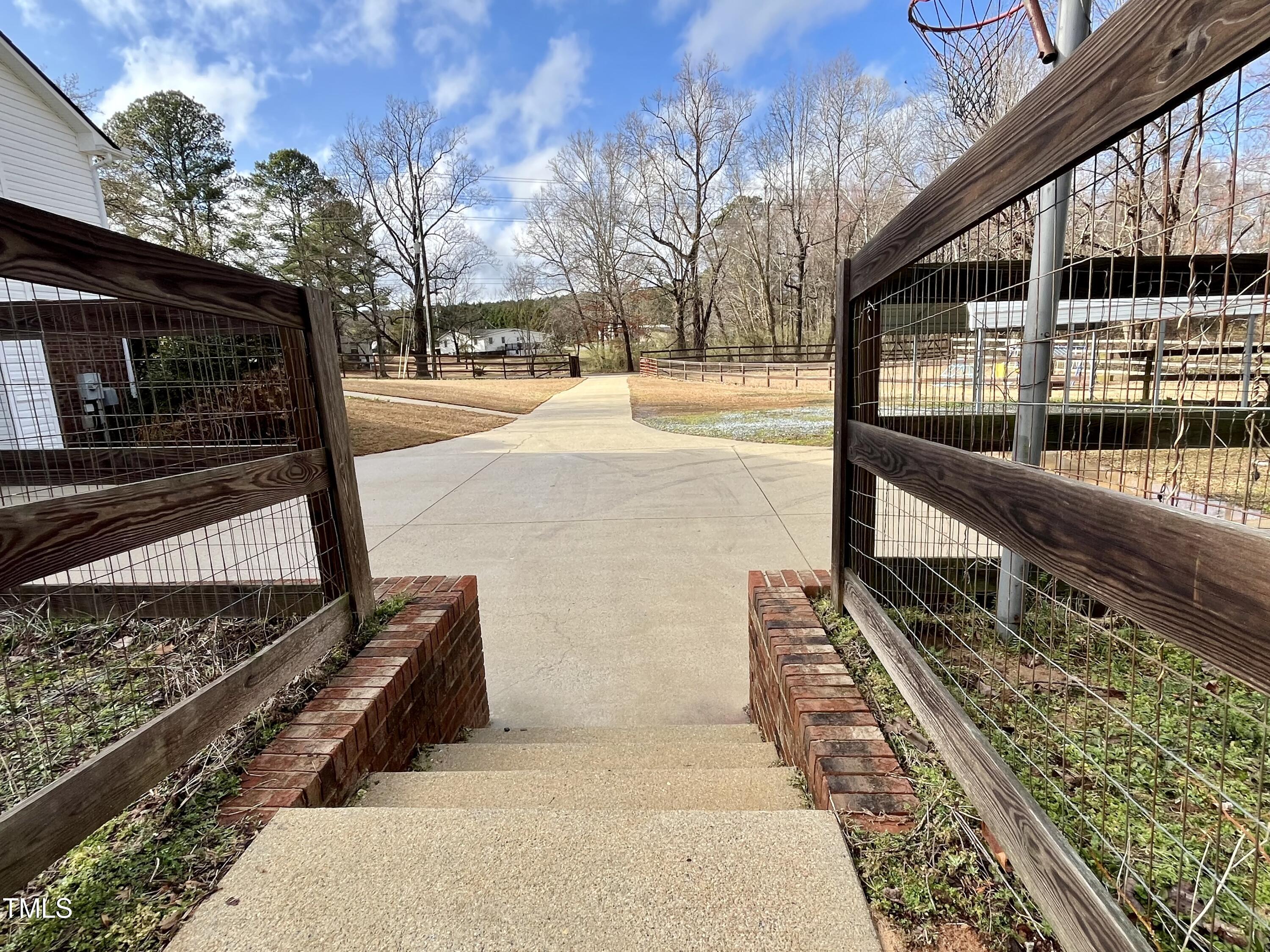 3733 Polenta Road Clayton, NC 27520 - Photo 34 of 51 a view of a pathway of a house with a yard