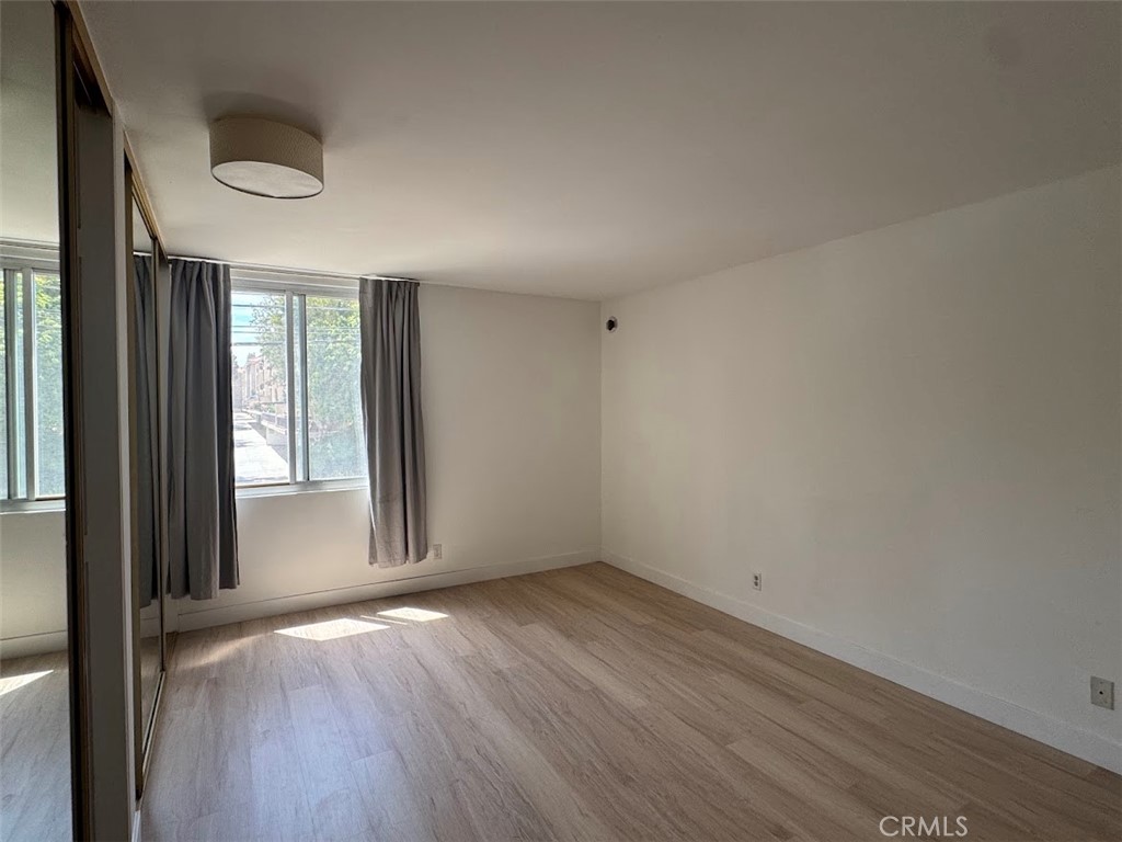 8740 Tuscany Avenue Playa del Rey, CA 90293 - Photo 10 of 21 an empty room with wooden floor and windows