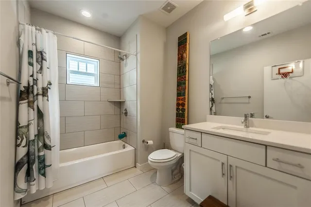 a bathroom with a double vanity sink a mirror and a shower