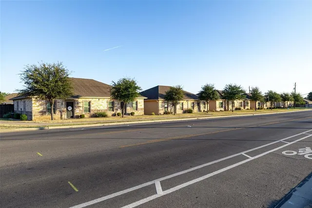 a view of a street and a cars parked on the road