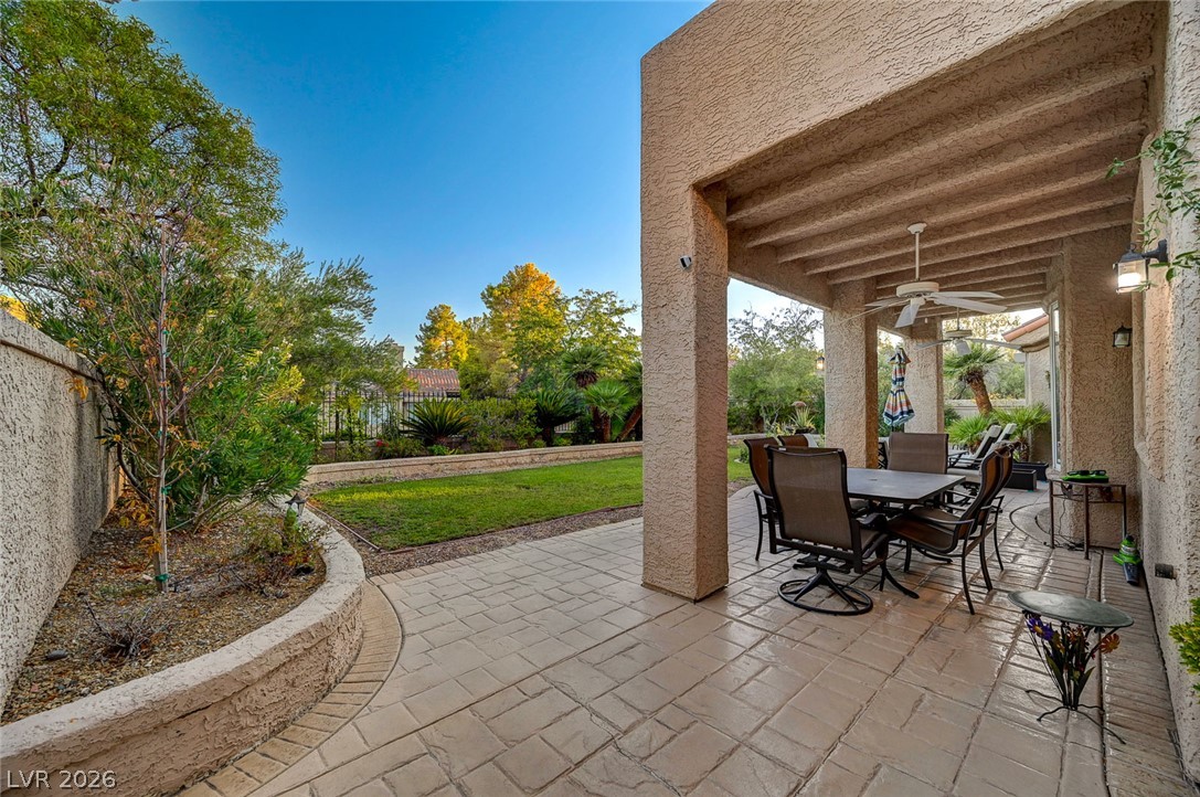 7995 Rio Rico Drive Las Vegas, NV 89113 - Photo 51 of 92 An inviting covered patio featuring a stamped concrete floor extends to a verdant lawn.
