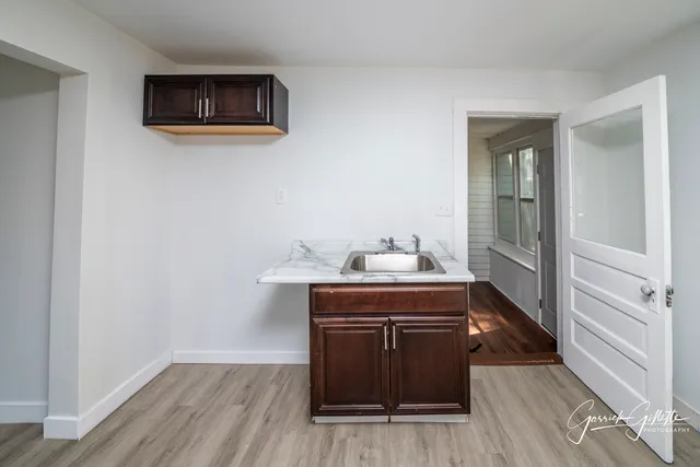 a room with a sink and a mirror