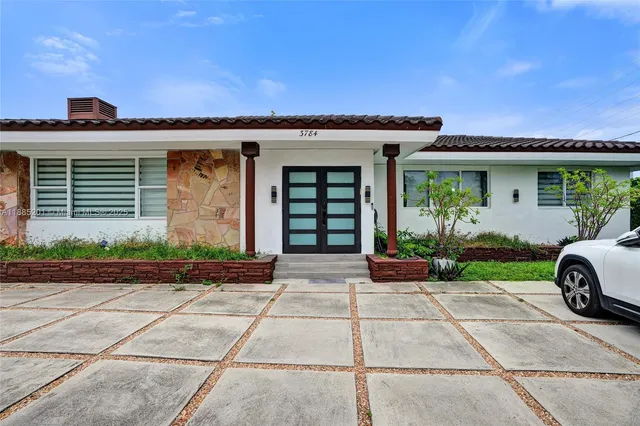 a front view of a house with garden