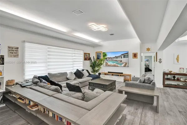 a living room with furniture and a large window