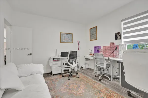 a view of a livingroom with workspace and a couch