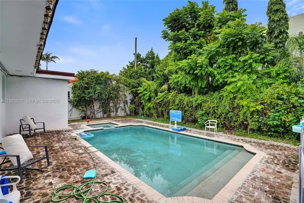 a swimming pool with outdoor seating and yard