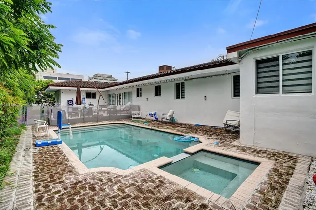 a view of a swimming pool with a patio
