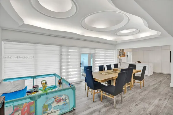 a view of a dining room with furniture and wooden floor