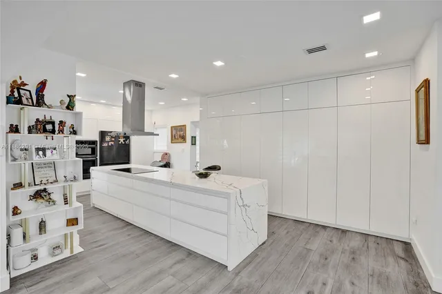 a kitchen with stainless steel appliances a refrigerator and a sink