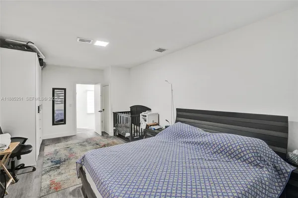 a bedroom with two beds and a window