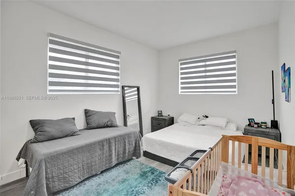 a view of a livingroom with wooden floor and furniture