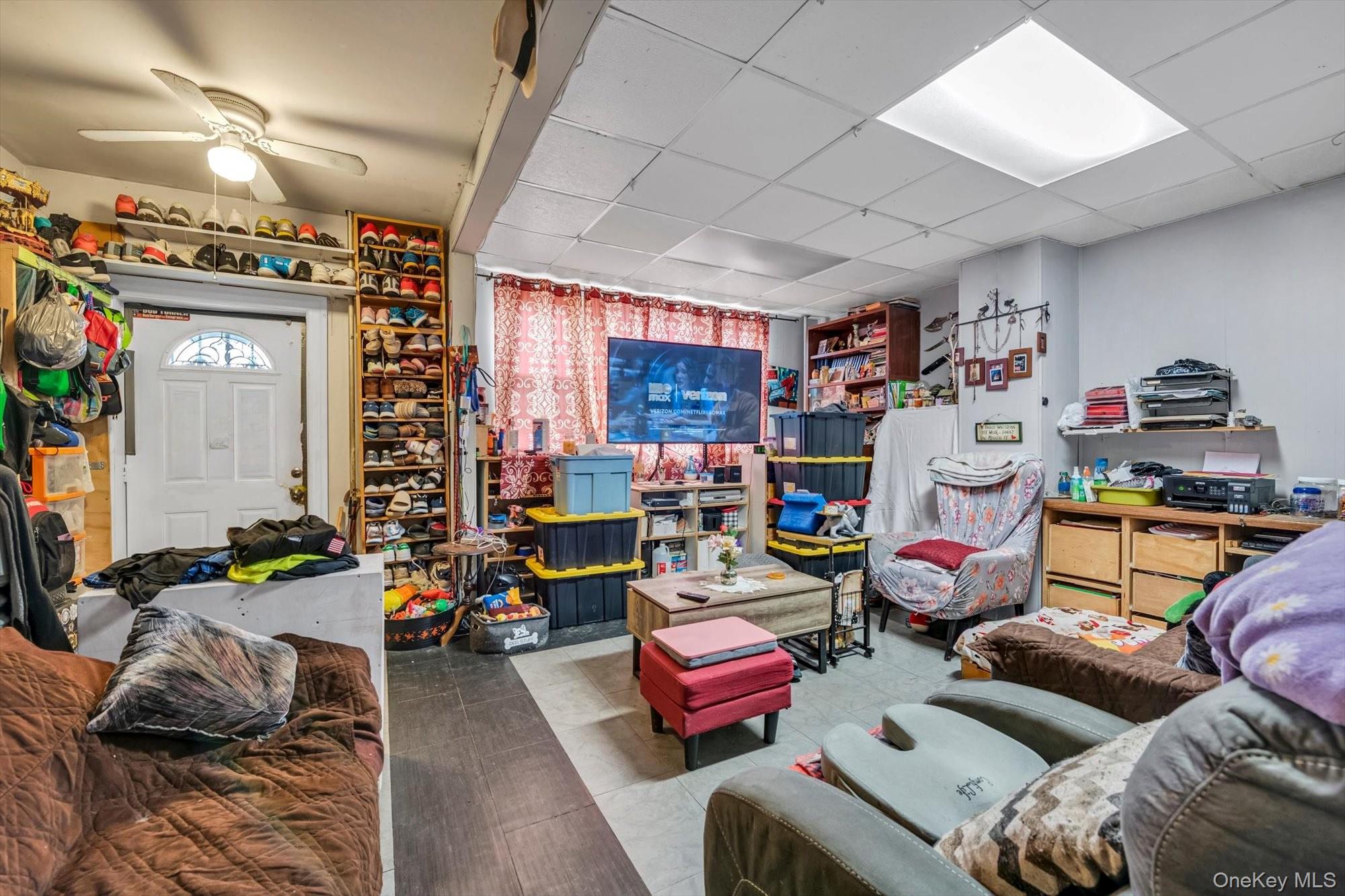 88-35 75th Street Queens, NY 11421 - Photo 2 of 11 a living room with furniture toys and a flat screen tv