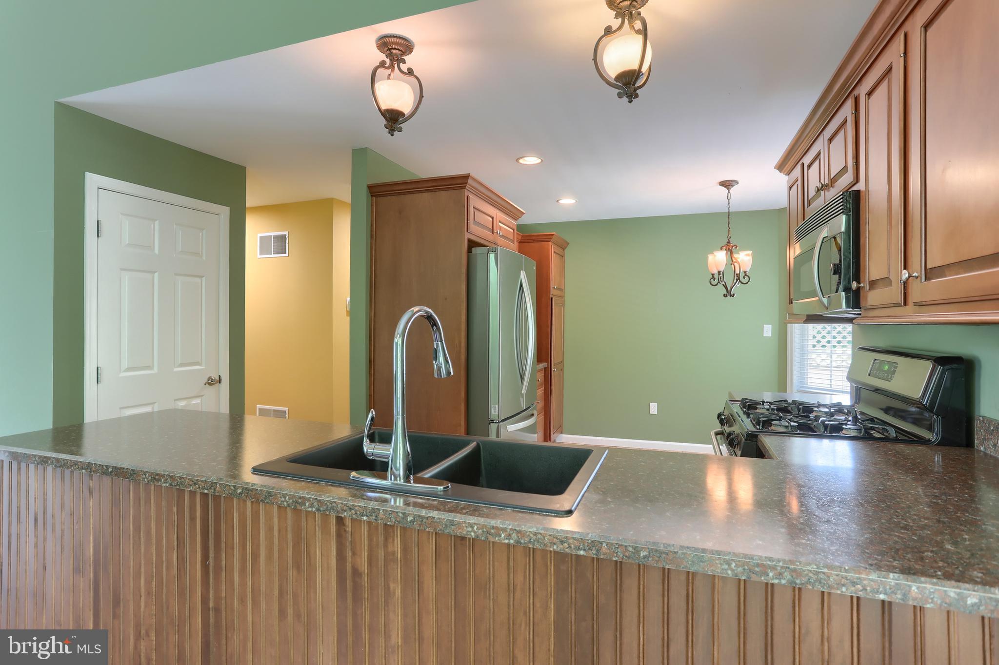 112 Crooked Hill Road Hummelstown, PA 17036 - Photo 15 of 51 a kitchen with stainless steel appliances granite countertop a sink dishwasher a stove with wooden cabinets and floor