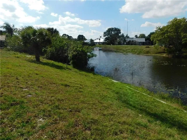 a view of a lake with houses in the back