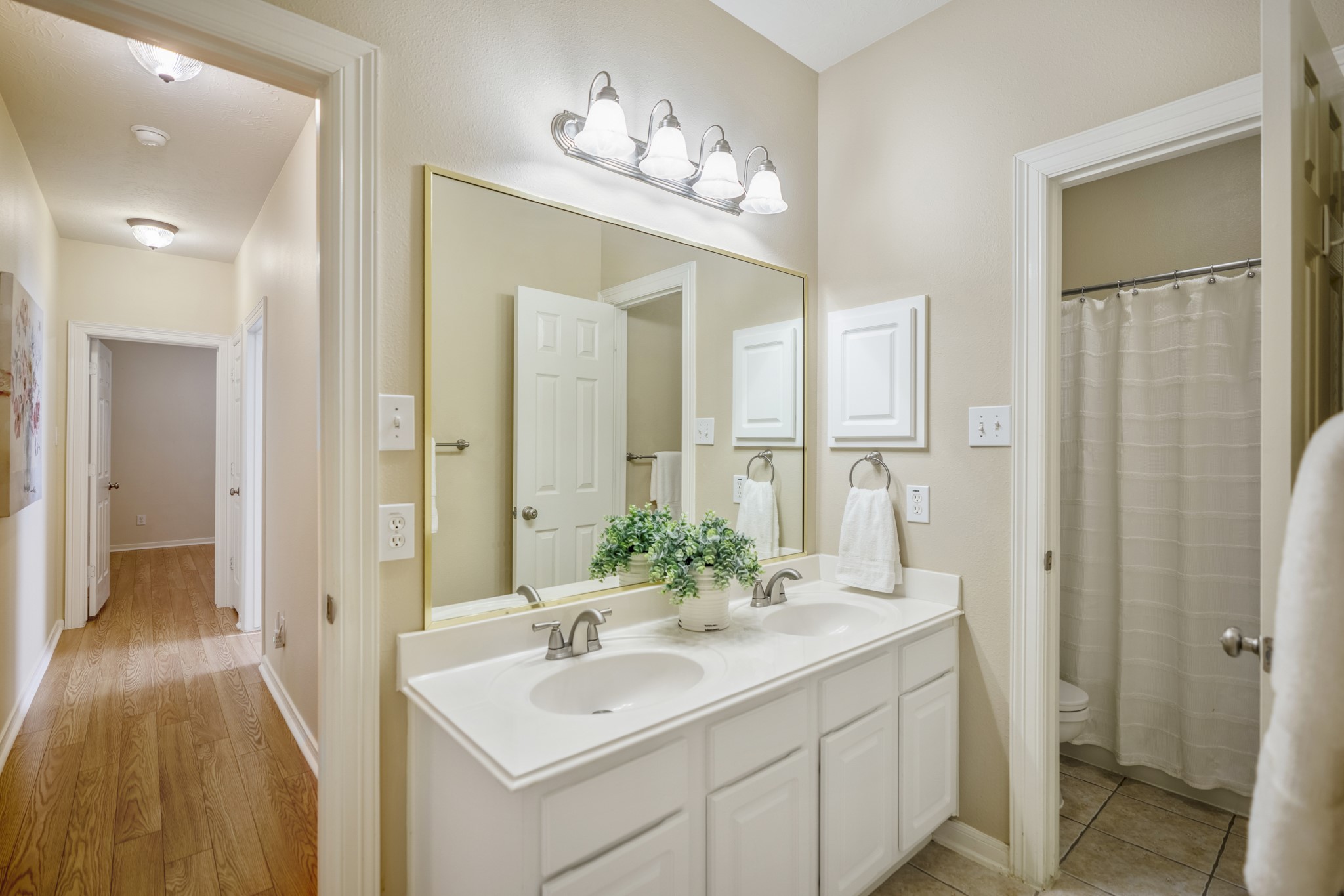 6218 Stone Trail Lane Spring, TX 77379 - Photo 24 of 50 Just outside the secondary bedrooms, the hall bath is set up for easy everyday use with a wide vanity, ample counter space, and a full tub/shower tucked to the side. Positioned off the main hallway, it keeps morning routines efficient while staying convenient to both guest rooms and the shared living spaces nearby.