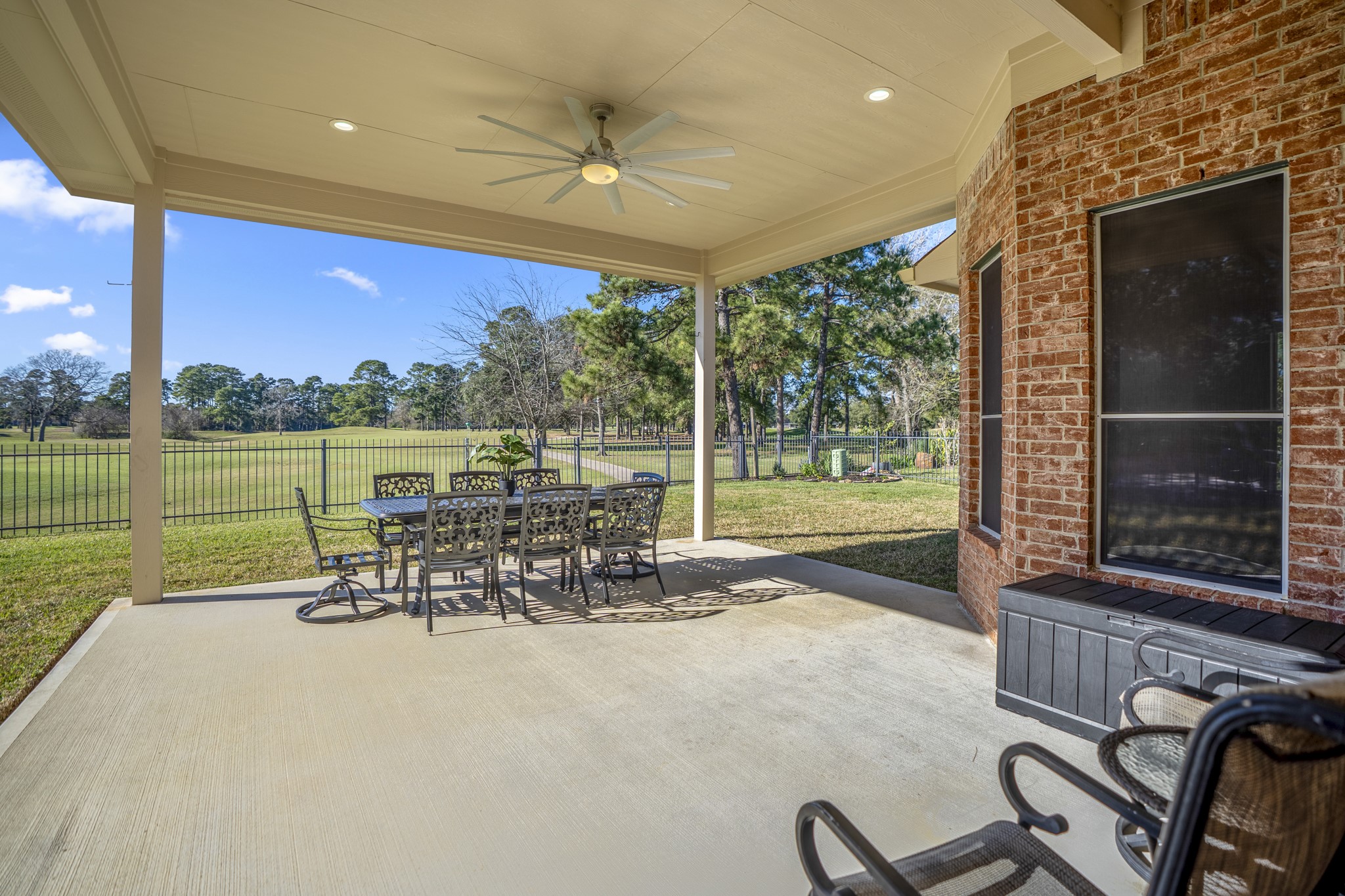 6218 Stone Trail Lane Spring, TX 77379 - Photo 29 of 50 Evenings here are about the view—wide open greens, visiting birds, and sunsets that quietly steal the show from the comfort of the covered patio.