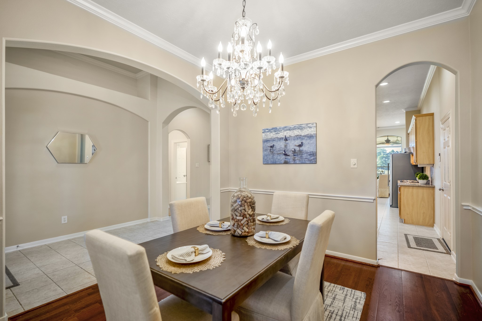 6218 Stone Trail Lane Spring, TX 77379 - Photo 6 of 50 Arched openings frame the dining room and keep the layout open and connected, offering clear views back to the entry hall and ahead into the kitchen. This perspective highlights how easily the spaces flow together, making it easy to move between hosting, everyday meals, and casual gatherings.