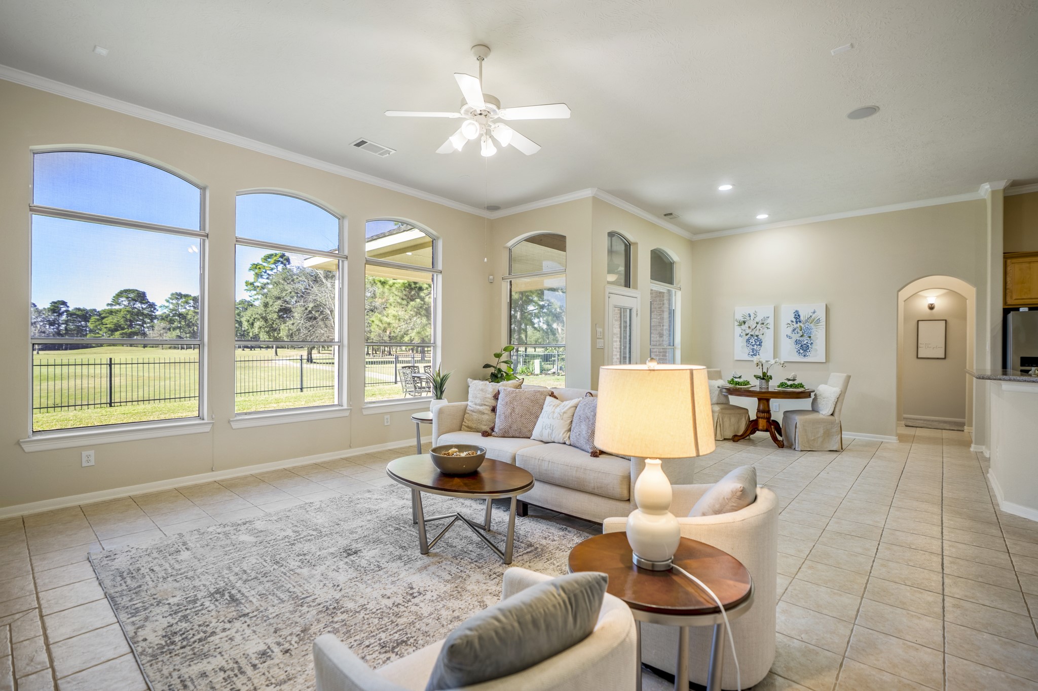 6218 Stone Trail Lane Spring, TX 77379 - Photo 10 of 50 Walls of windows line the living area, framing wide-open views and filling the space with natural light throughout the day. With the breakfast nook and kitchen just beyond, the layout keeps everything connected—perfect for easy mornings, casual meals, and relaxed evenings at home.