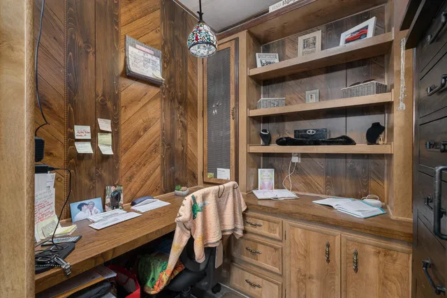 a bedroom with a bed a chandelier and closet