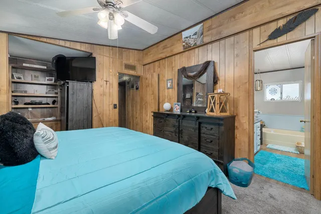 a bathroom with a double vanity sink a mirror and a bathtub