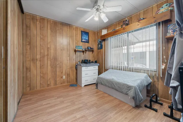 a bedroom with bed and a window