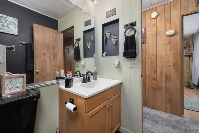 a bathroom with sink a mirror a toilet and shower