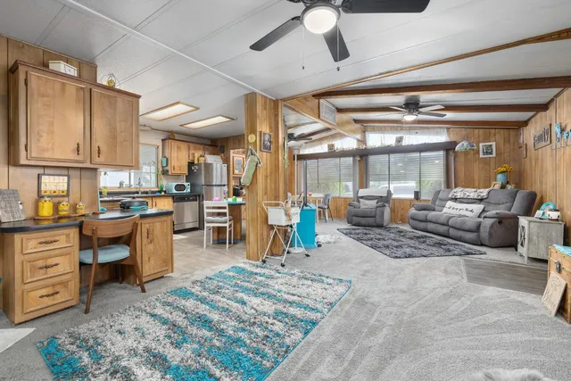 a kitchen with stainless steel appliances kitchen island granite countertop a refrigerator a stove and a sink with dishwasher