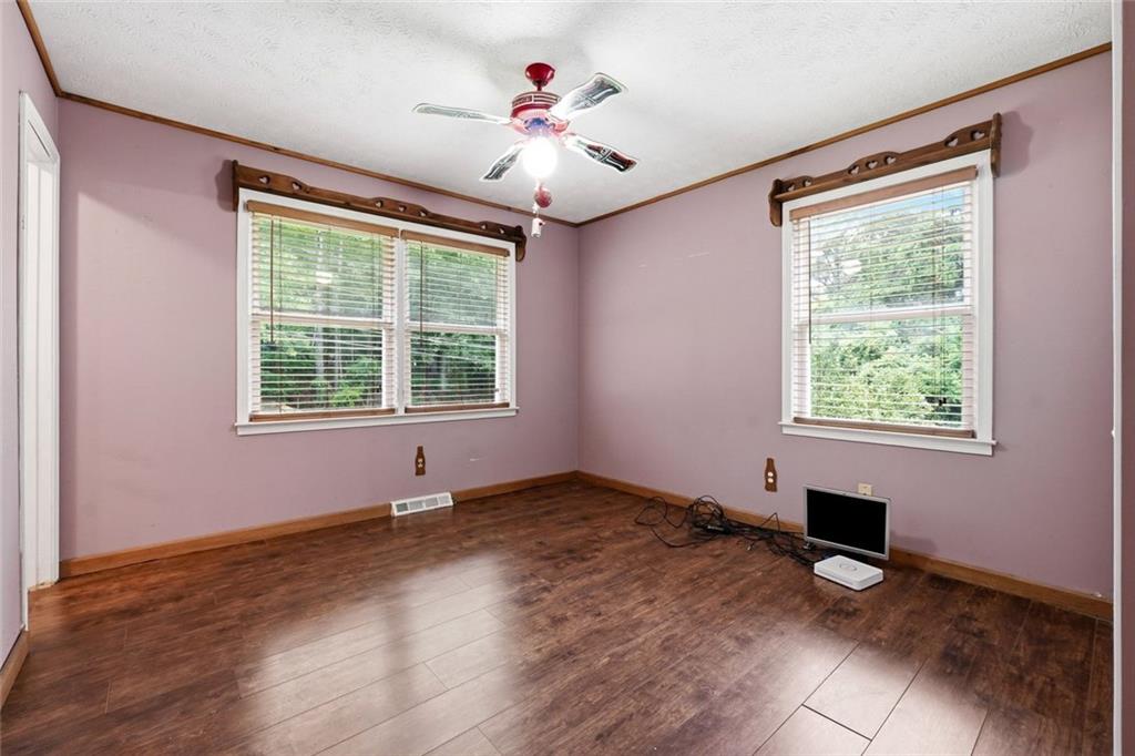 399 Donahoo Road Southeast Silver Creek, GA 30173 - Photo 13 of 22 a view of an empty room with window and wooden floor