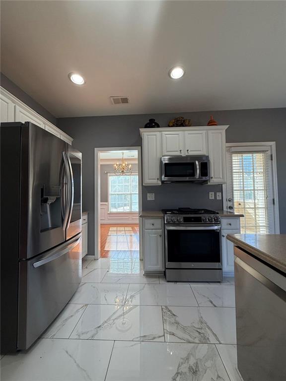 1009 South Creek Drive Villa Rica, GA 30180 - Photo 21 of 61 a kitchen with stainless steel appliances granite countertop a refrigerator and a stove top oven