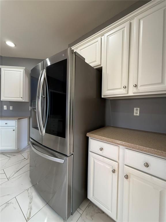 1009 South Creek Drive Villa Rica, GA 30180 - Photo 22 of 61 a kitchen with white cabinets and stainless steel appliances