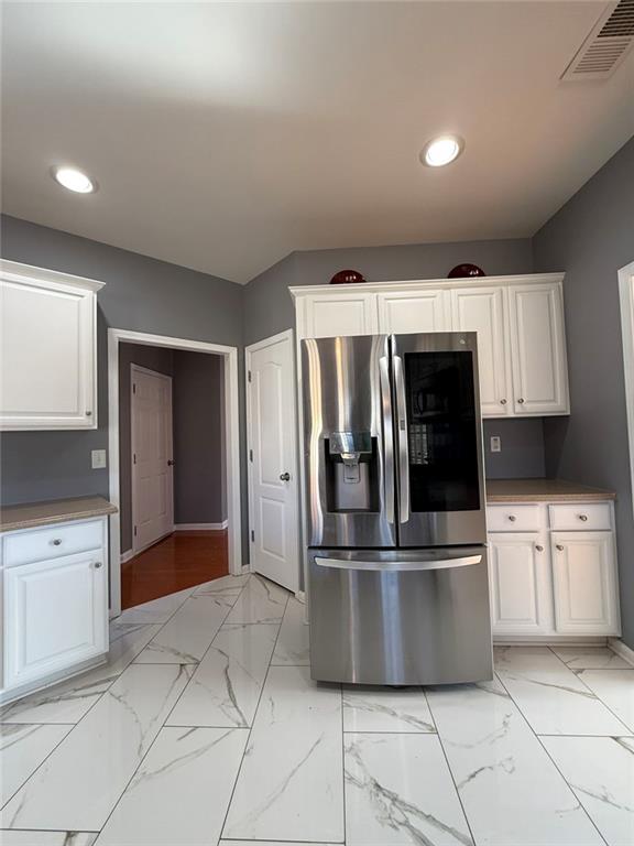 1009 South Creek Drive Villa Rica, GA 30180 - Photo 24 of 61 a kitchen with stainless steel appliances kitchen island granite countertop a refrigerator and white cabinets