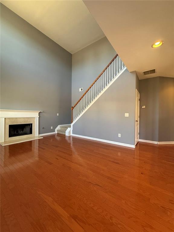 1009 South Creek Drive Villa Rica, GA 30180 - Photo 29 of 61 a view of an empty room with wooden floor and a fireplace
