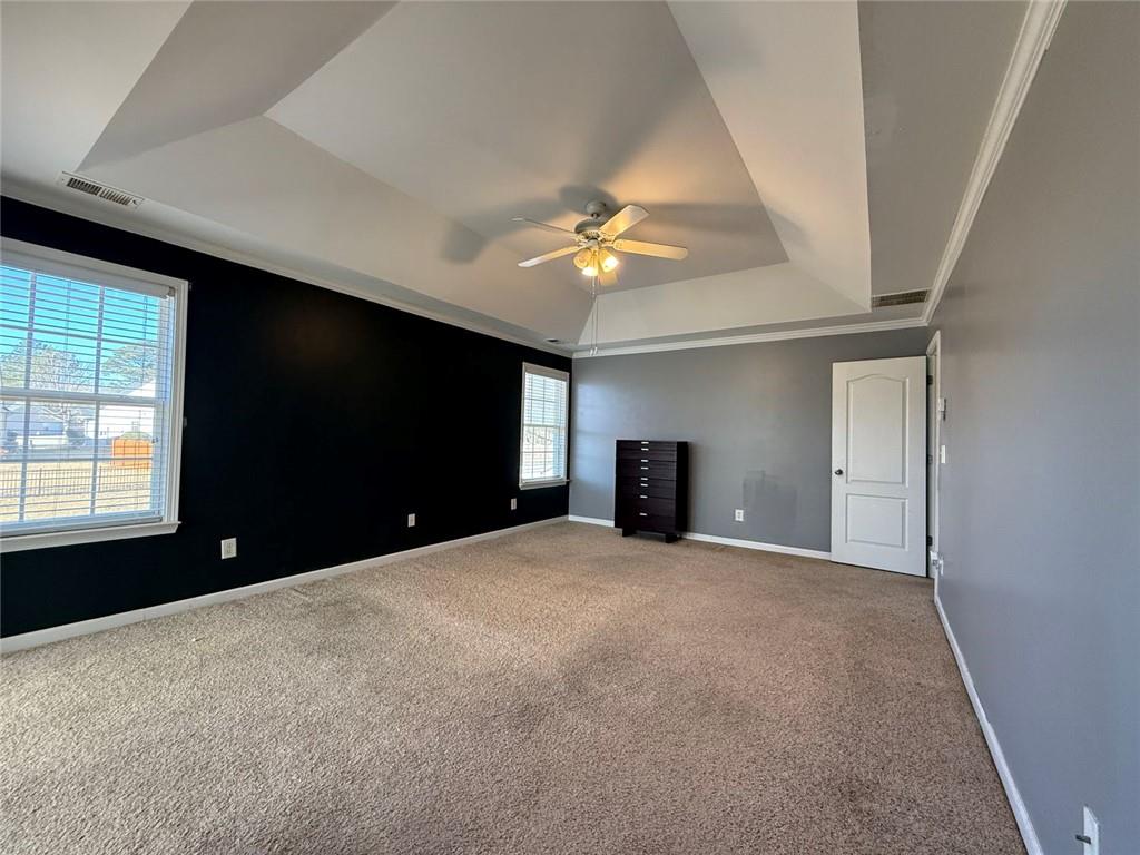 1009 South Creek Drive Villa Rica, GA 30180 - Photo 46 of 61 en empty room with windows and a ceiling fan