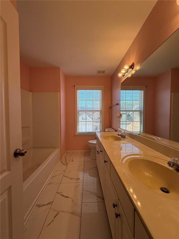 1009 South Creek Drive Villa Rica, GA 30180 - Photo 55 of 61 a spacious bathroom with a granite countertop sink a mirror and a bathtub