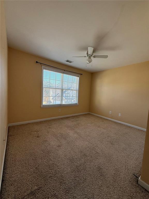 1009 South Creek Drive Villa Rica, GA 30180 - Photo 59 of 61 an empty room with windows and ceiling fan