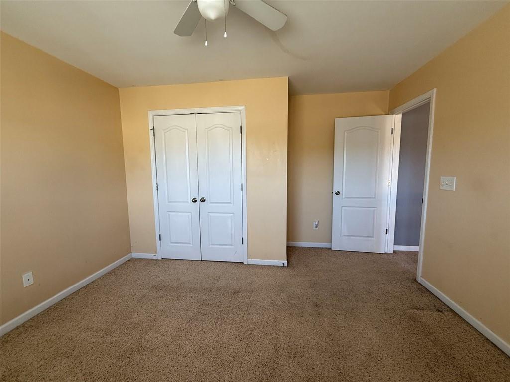 1009 South Creek Drive Villa Rica, GA 30180 - Photo 60 of 61 an empty room with closet and a chandelier fan