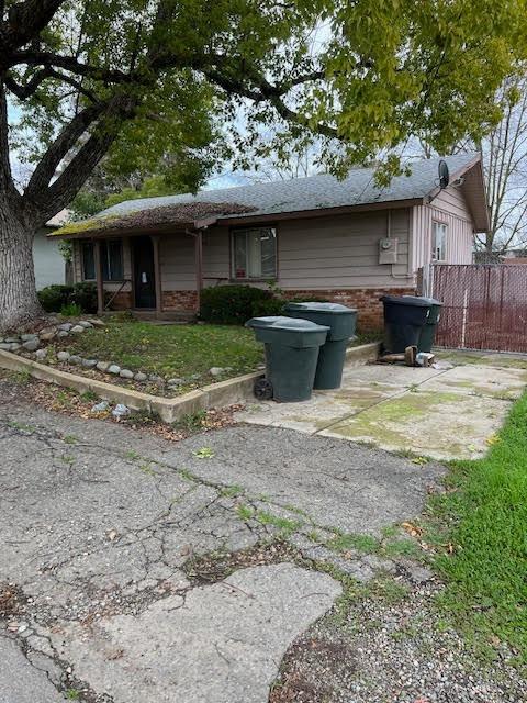 a view of a house with backyard sitting area and garden