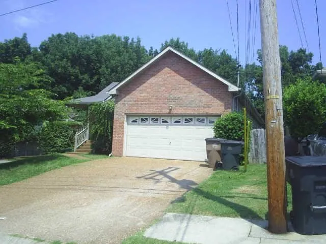 a view of a house with a yard plants and a big yard