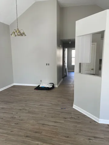 a view of a living room with hardwood floor and cabinet