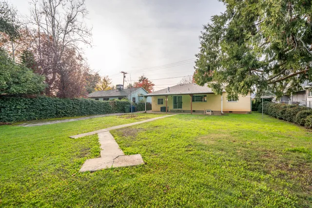 a front view of a house with yard and green space