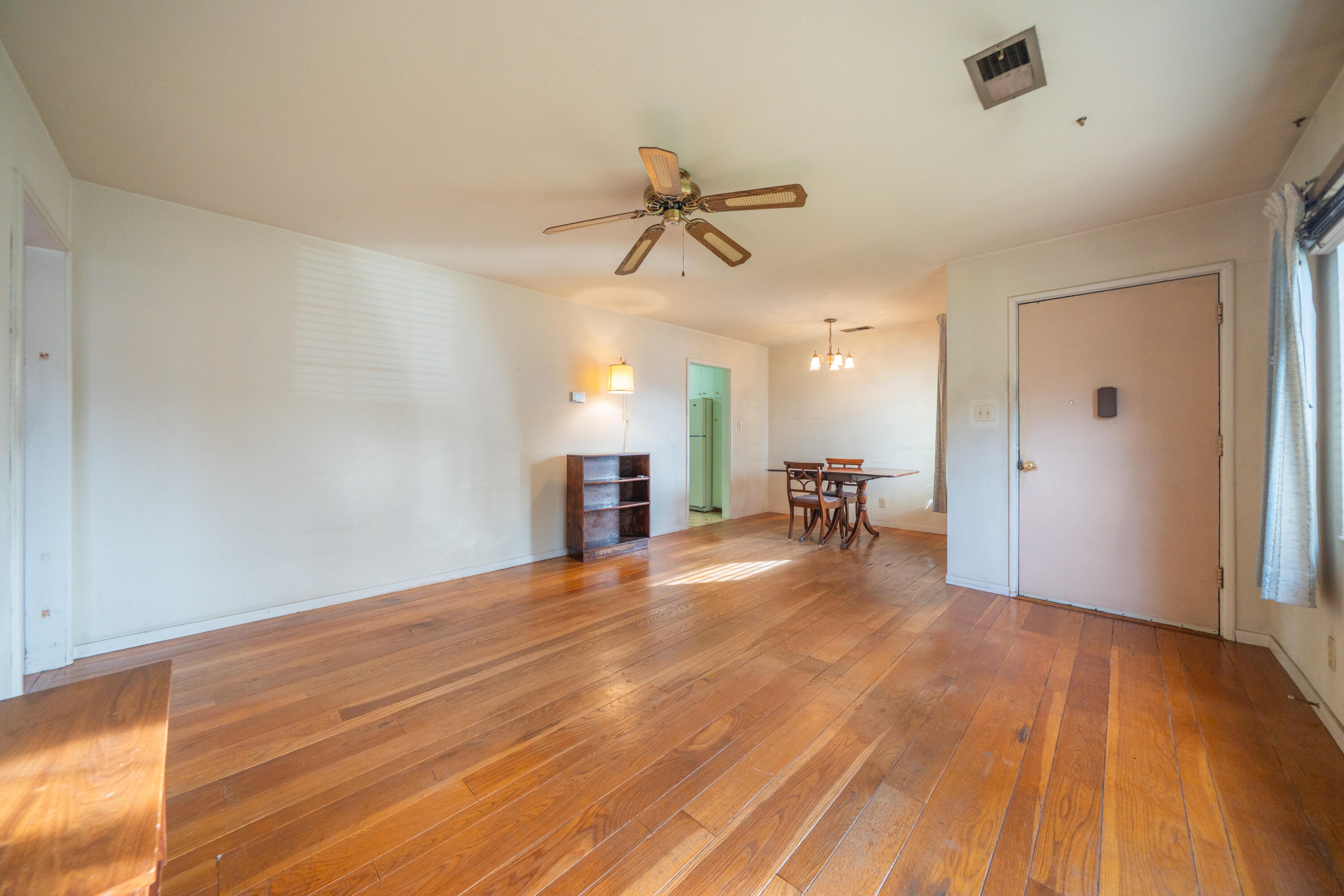 1209 C Street Redding, CA 96002 - Photo 7 of 48 a view of a livingroom with a ceiling fan and hardwood floor