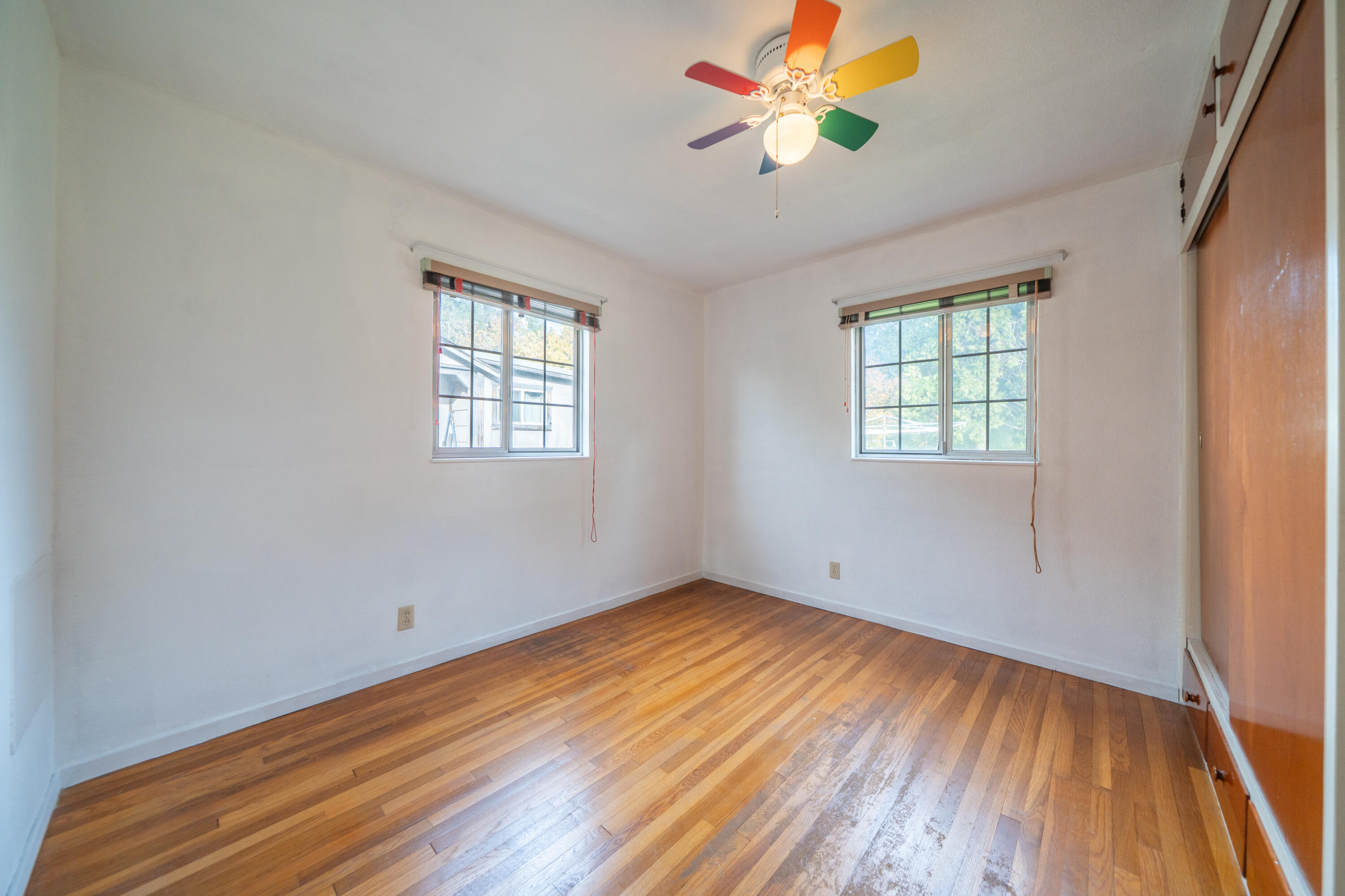 1209 C Street Redding, CA 96002 - Photo 10 of 48 wooden floor in an empty room with a window