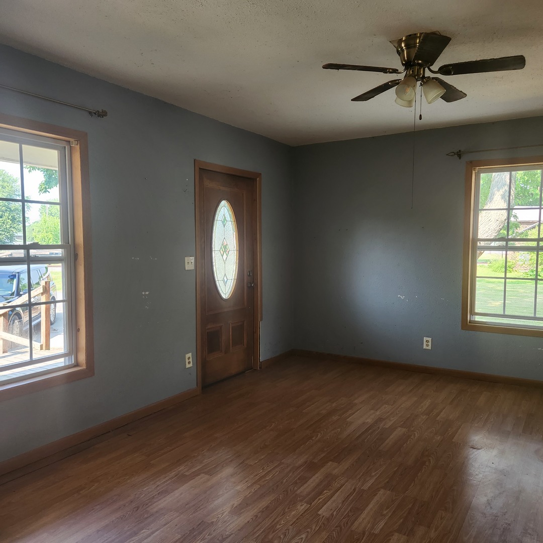 Undisclosed Address Sheldon, IL 60966 - Photo 17 of 24 an empty room with windows and a chandelier fan