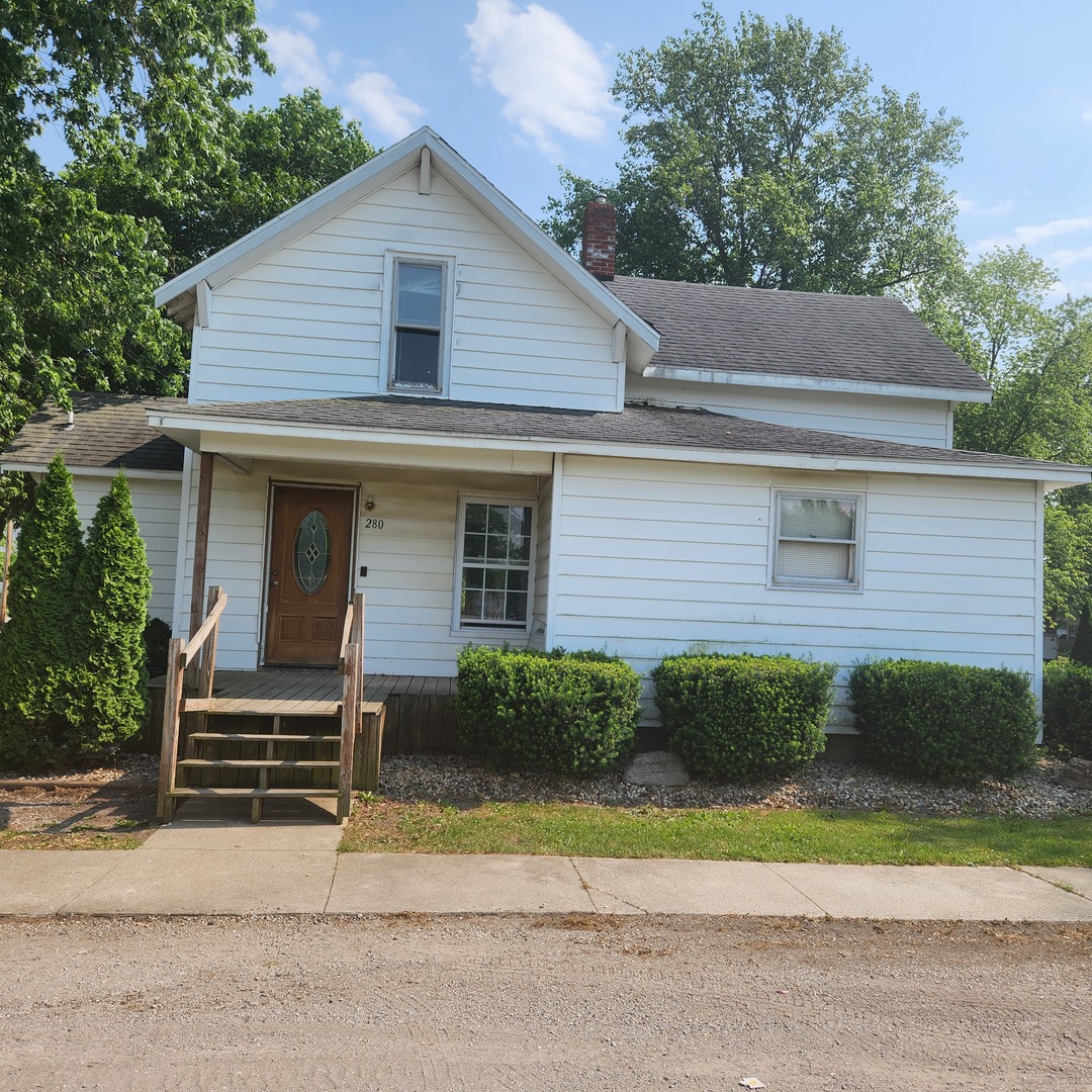 Undisclosed Address Sheldon, IL 60966 - Photo 18 of 24 a front view of a house with a yard and garage