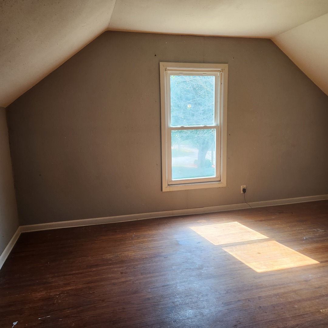 Undisclosed Address Sheldon, IL 60966 - Photo 9 of 24 an empty room with wooden floor and windows