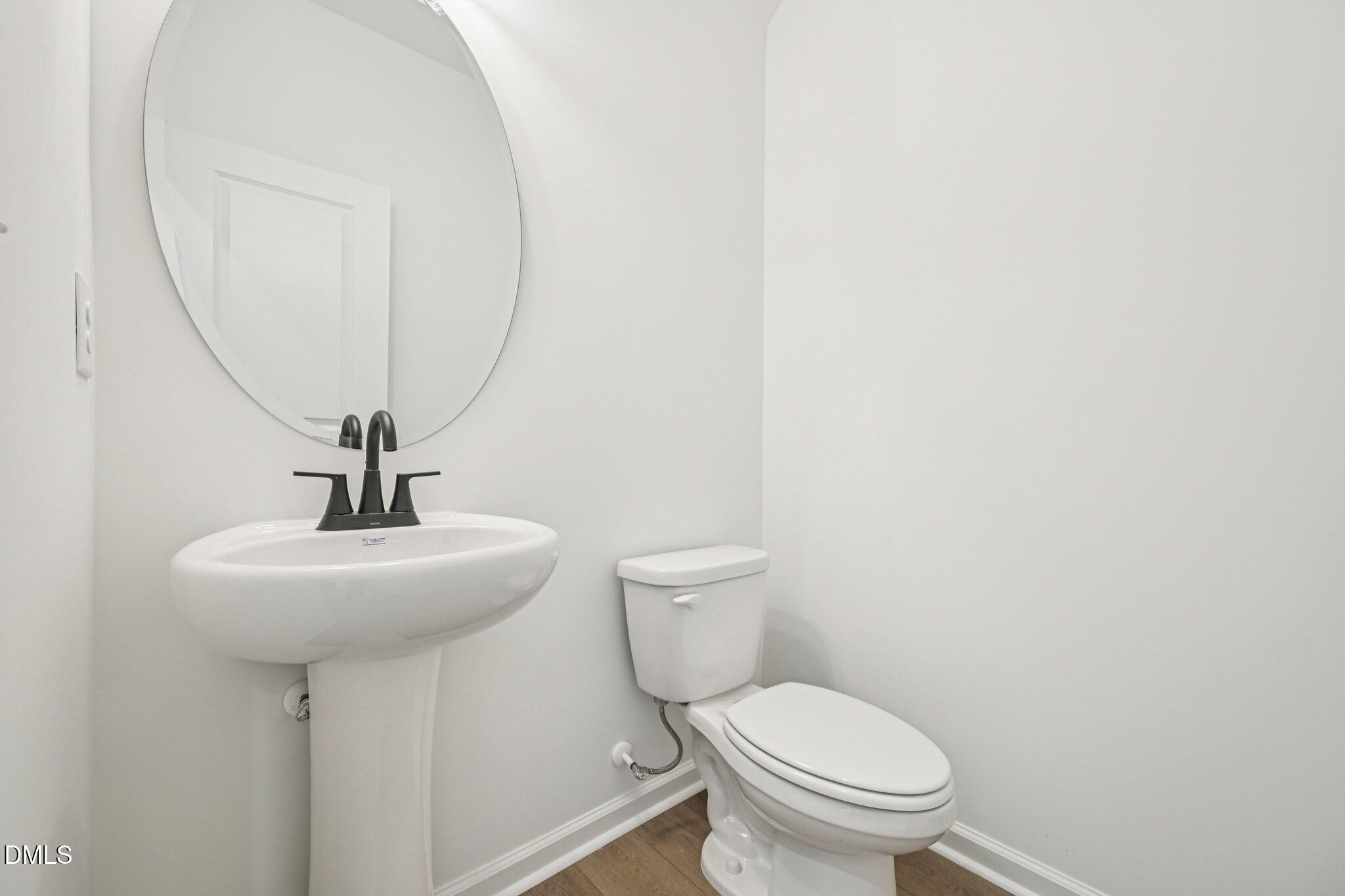 142 North Harvest Rdg Way, Unit HOMESITE 310 Clayton, NC 27520 - Photo 17 of 43 a bathroom with a toilet a sink and a mirror