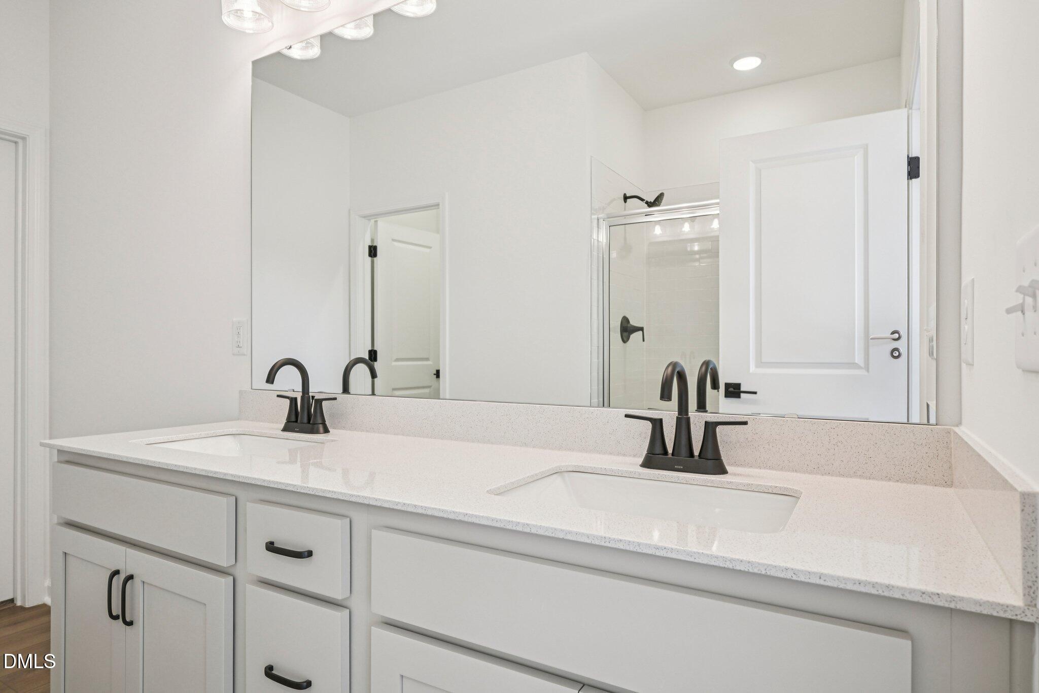 142 North Harvest Rdg Way, Unit HOMESITE 310 Clayton, NC 27520 - Photo 19 of 43 a bathroom with a sink and a mirror