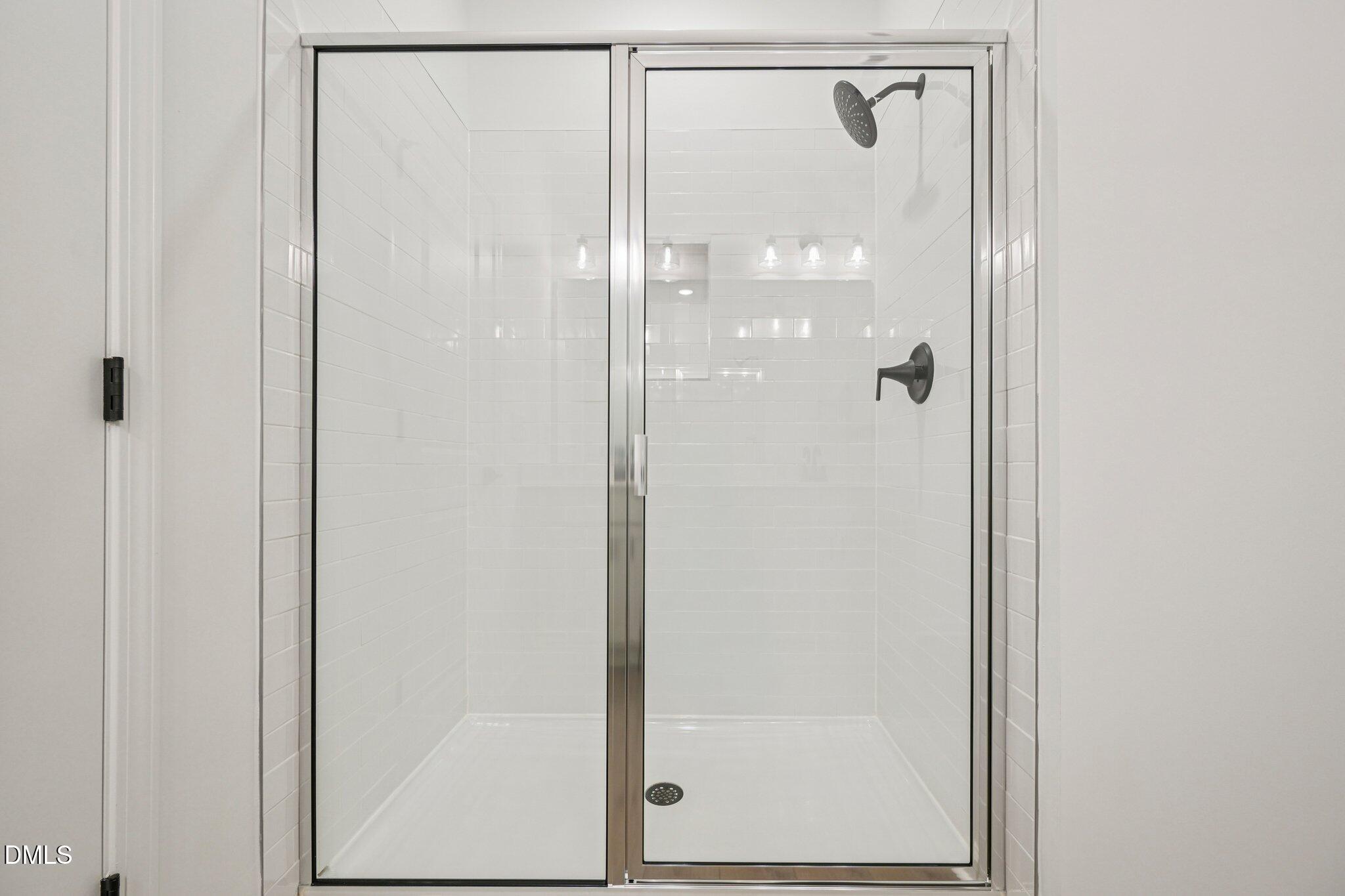 142 North Harvest Rdg Way, Unit HOMESITE 310 Clayton, NC 27520 - Photo 20 of 43 a bathroom with a glass shower door