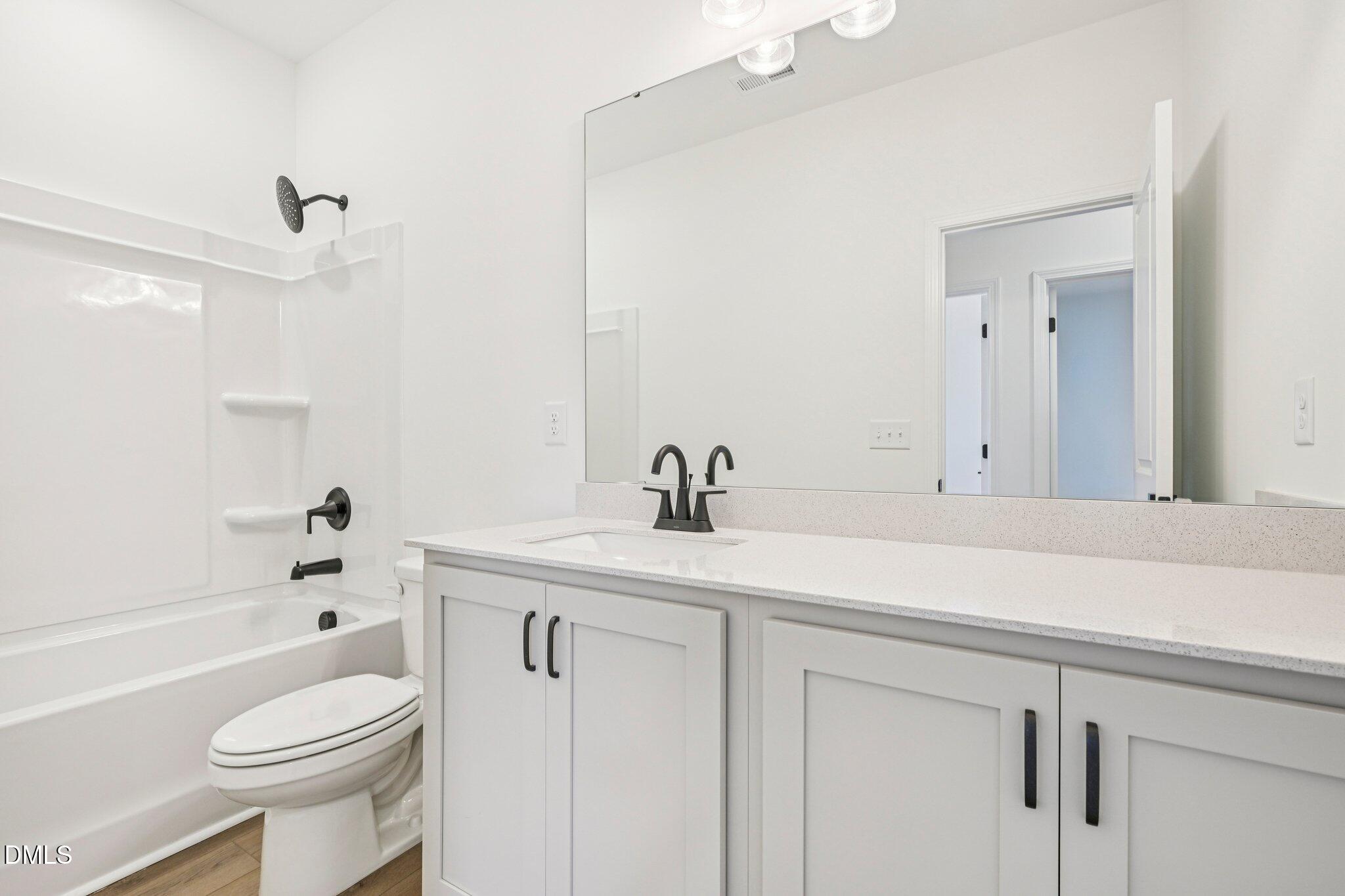 142 North Harvest Rdg Way, Unit HOMESITE 310 Clayton, NC 27520 - Photo 24 of 43 a bathroom with a sink a toilet and a bathtub